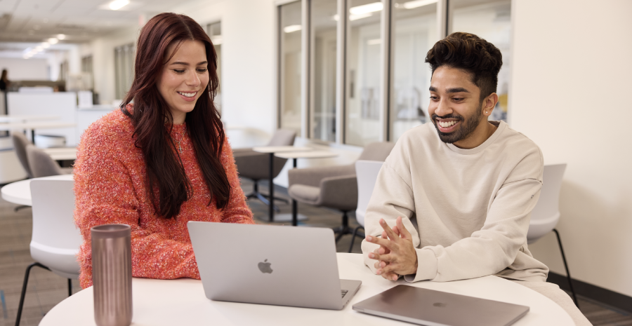 Two students using a laptop